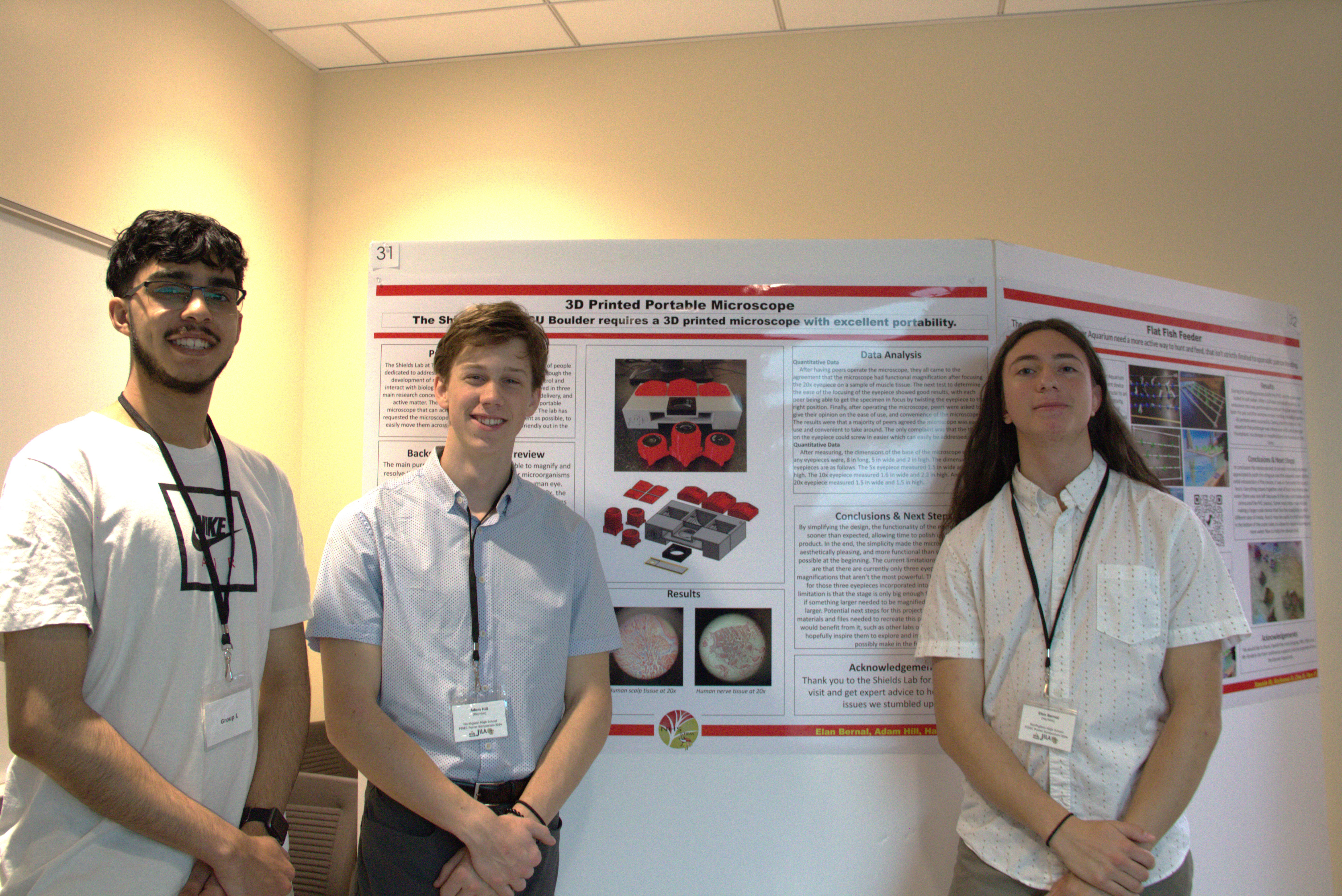 High school students stand in front of their 3D printed microscope project