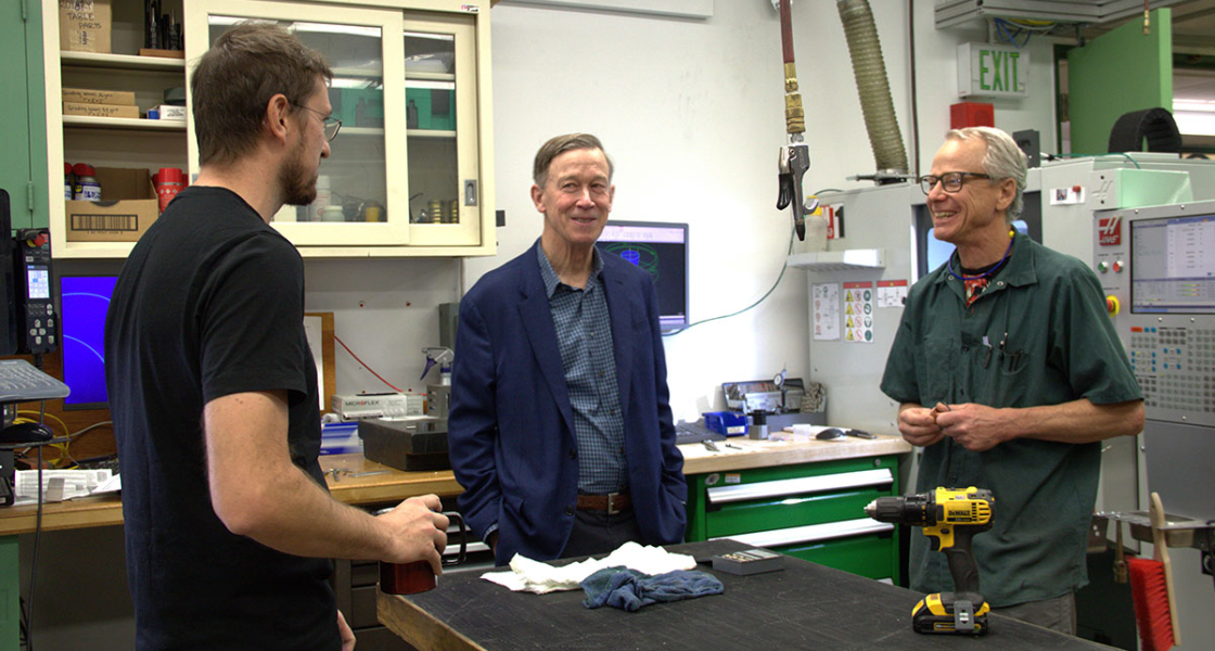 Senator Hickenlooper (center) talks to JILA's instrument shop head Kyle Thatcher (left) and JILA instrument maker Hans Green (right).