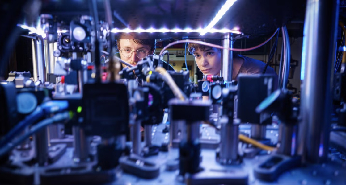 Kendall Mehling, left, and Catie LeDesma, right, with a new kind of atom "interferometer" on the CU Boulder campus. 