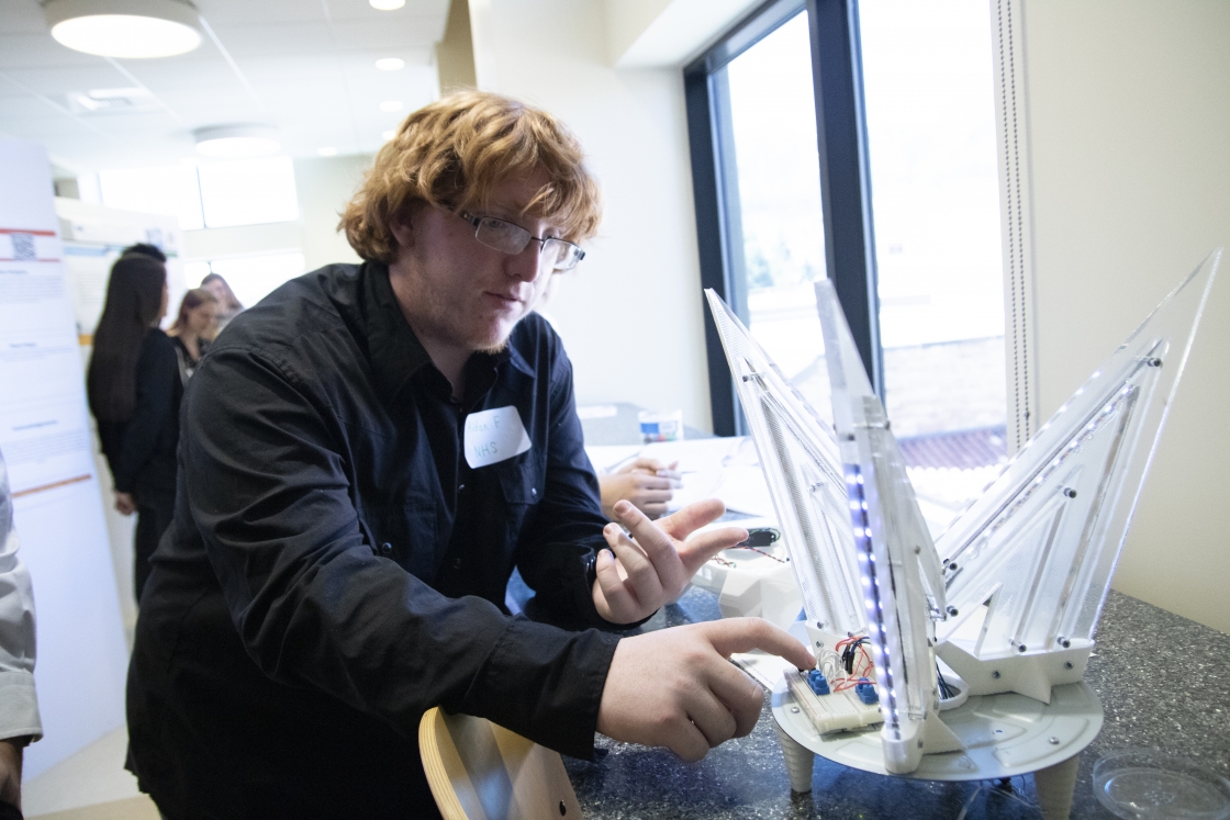 Aidan Floyd from Northglenn High School demonstrates a light display created from old computer monitors.