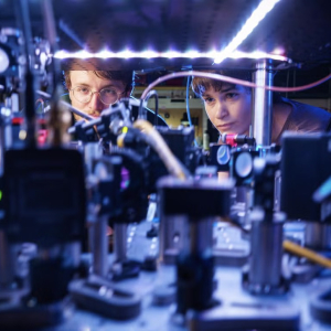 Kendall Mehling, left, and Catie LeDesma, right, with a new kind of atom "interferometer" on the CU Boulder campus. 