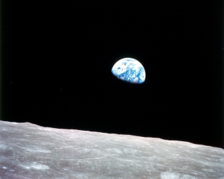 Photograph of earthrise over the Moon.