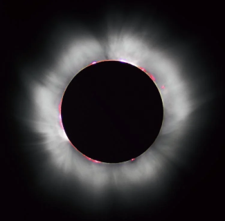 Radiation streaming from the sun's corona becomes visible during an eclipse