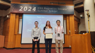 JILA graduate student Anya Grafov stands with her best poster award at the IEEE Magnetics Society Summer School in Taiwan