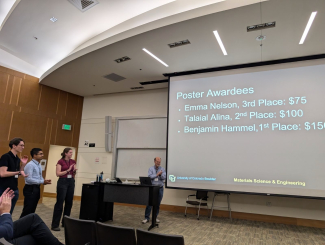 JILA graduate student Emma Nelson (left) claps as the award winners are announced at the CU Boulder Innovation in Materials Symposium 2024