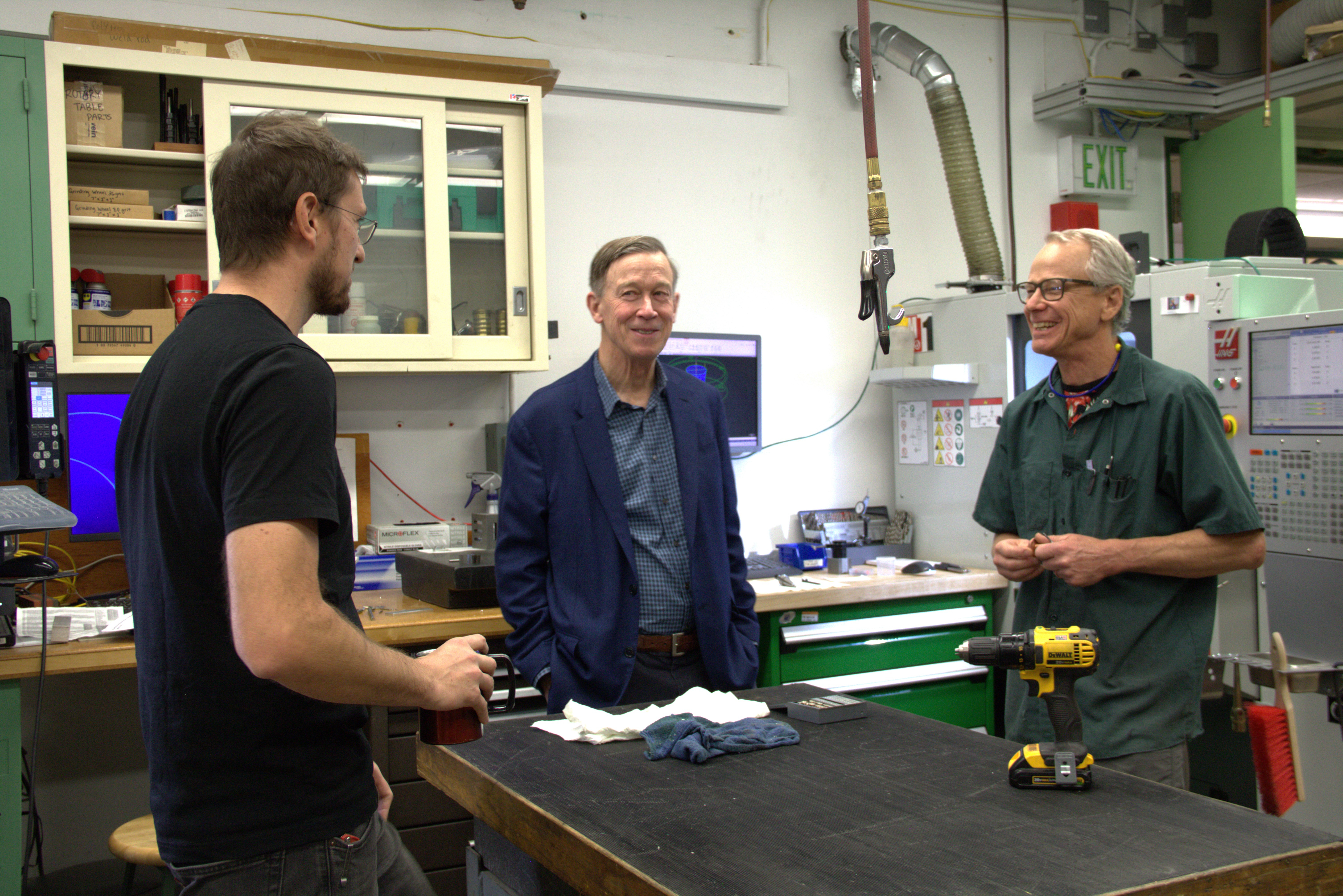 Senator Hickenlooper (center) talks to JILA's instrument shop head Kyle Thatcher (left) and JILA instrument maker Hans Green (right)