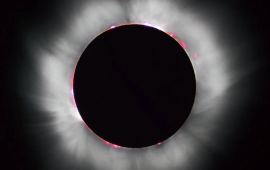Radiation streaming from the sun's corona becomes visible during an eclipse