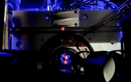 A look inside the optical atomic clock cavity, with the red light being a reflection of the laser light used in the optical lattice 