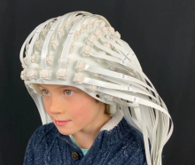 Child wears a helmet made up of more than 100 OPM sensors.